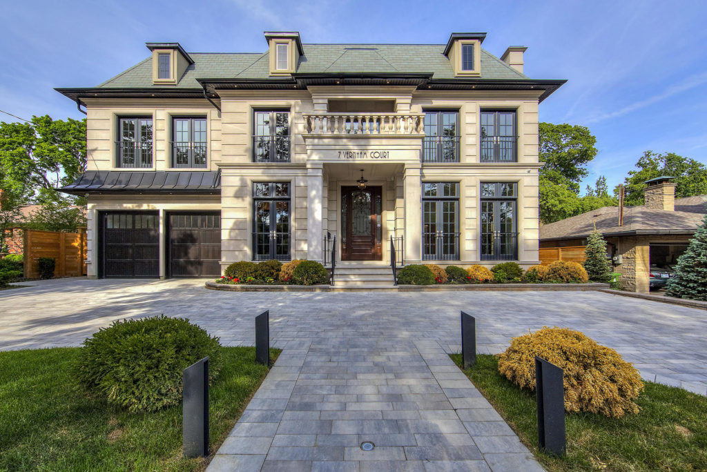 A large stone statue in front of a house

Description automatically generated